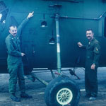 Captain Brian West and Major Tom Hill pointing out some bullet holes to their aircraft that killed the Crew Chief, Cpl. John Wiseman of St. Louis